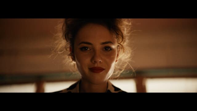 Cinematic video frame featuring a centered subject and dramatic lighting